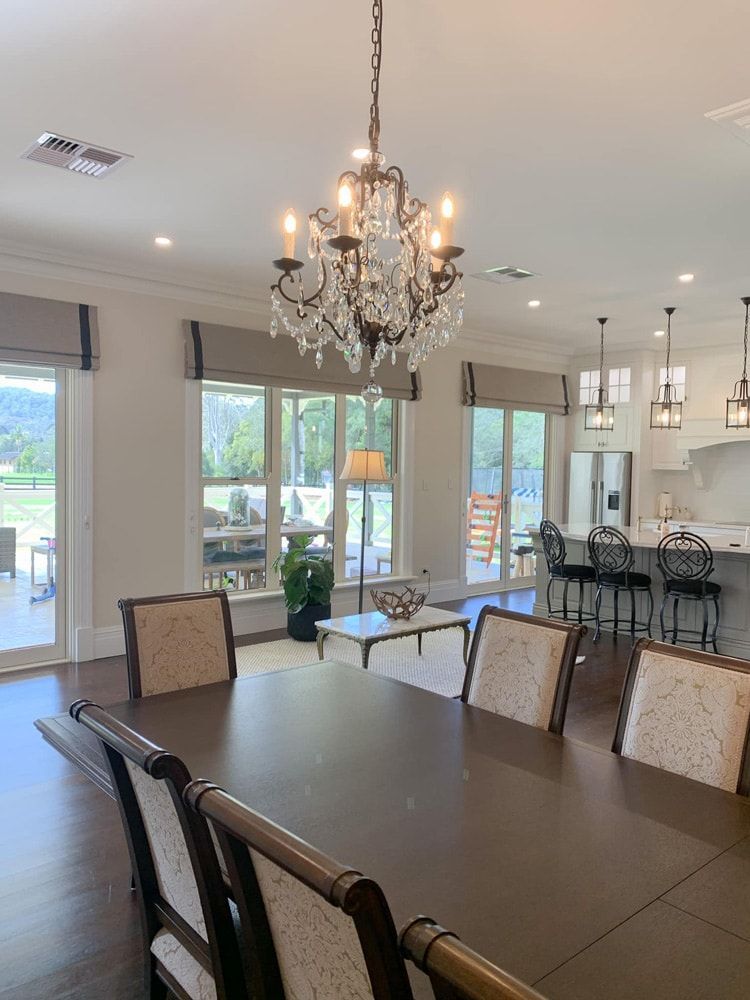 A Dining Room With A Table And Chairs — Ron Ayton Curtains, Blinds & Shutters In Shelly Beach, NSW