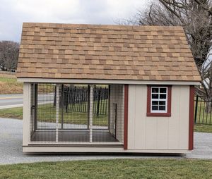 A dog kennel with a brown roof and a window