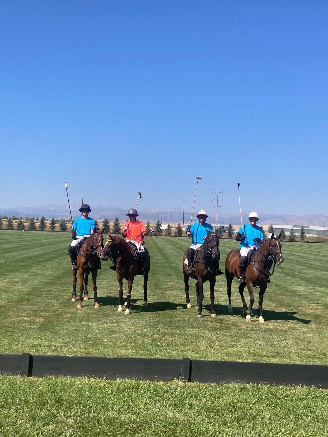 A group of people are riding horses on a field.