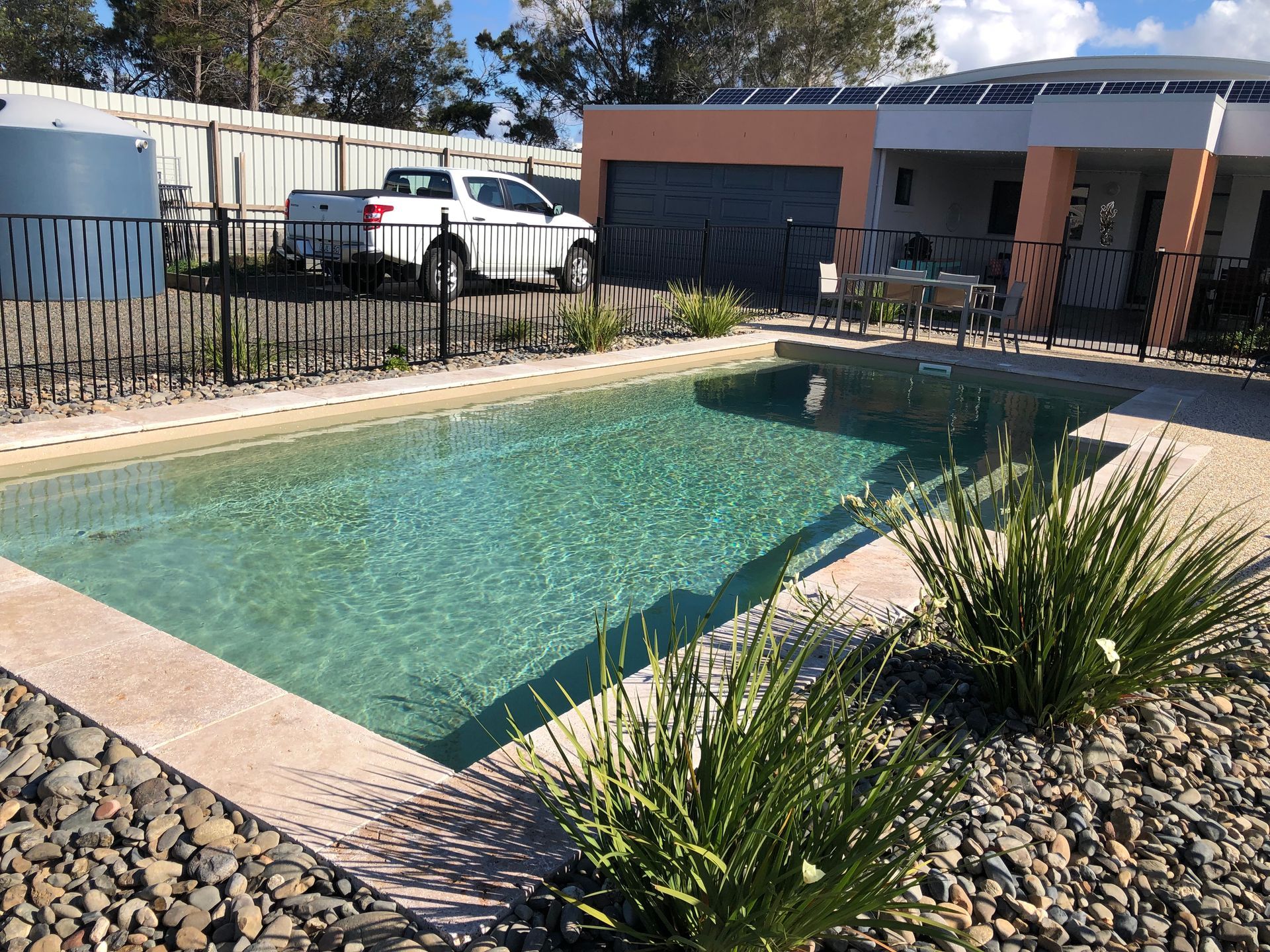 There is a Large Swimming Pool in the Backyard of a House