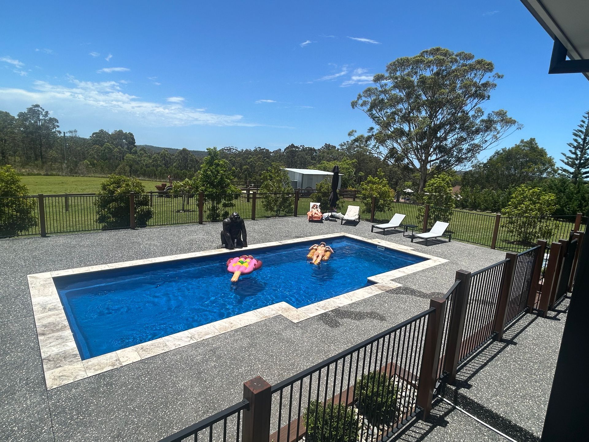 There is a Large Swimming Pool With a Gazebo in the Background — Steve Merrick Family Swimming Pools in Taree, NSW