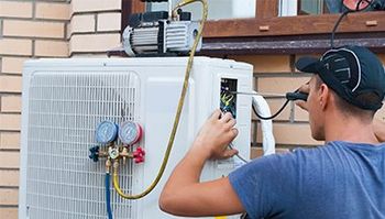 Worker Installs the Outdoor Unit of the Air Conditioner — El Paso, TX — Sun City Air Conditioning Co. Inc.