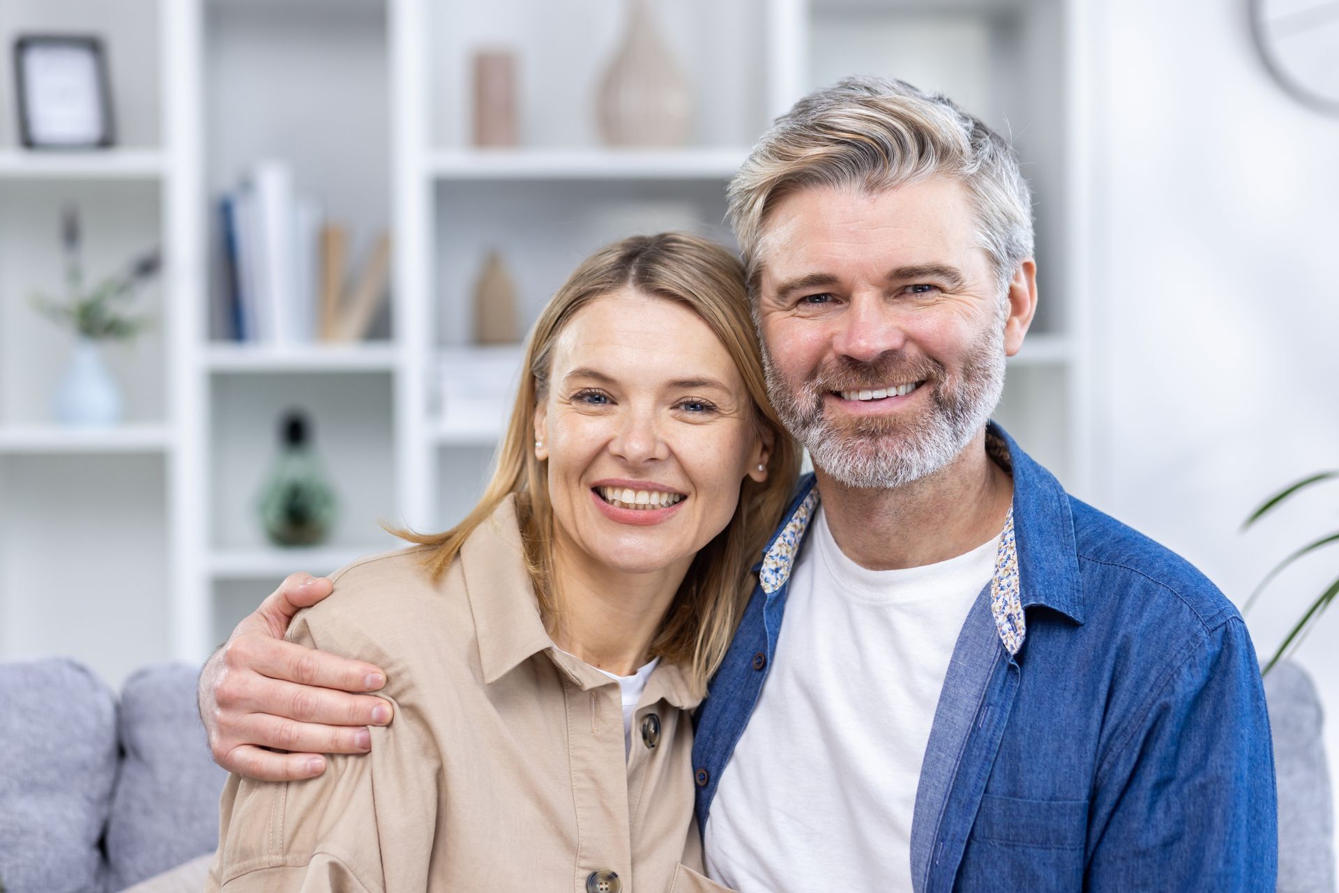 A man and a woman are shaking hands in an office.