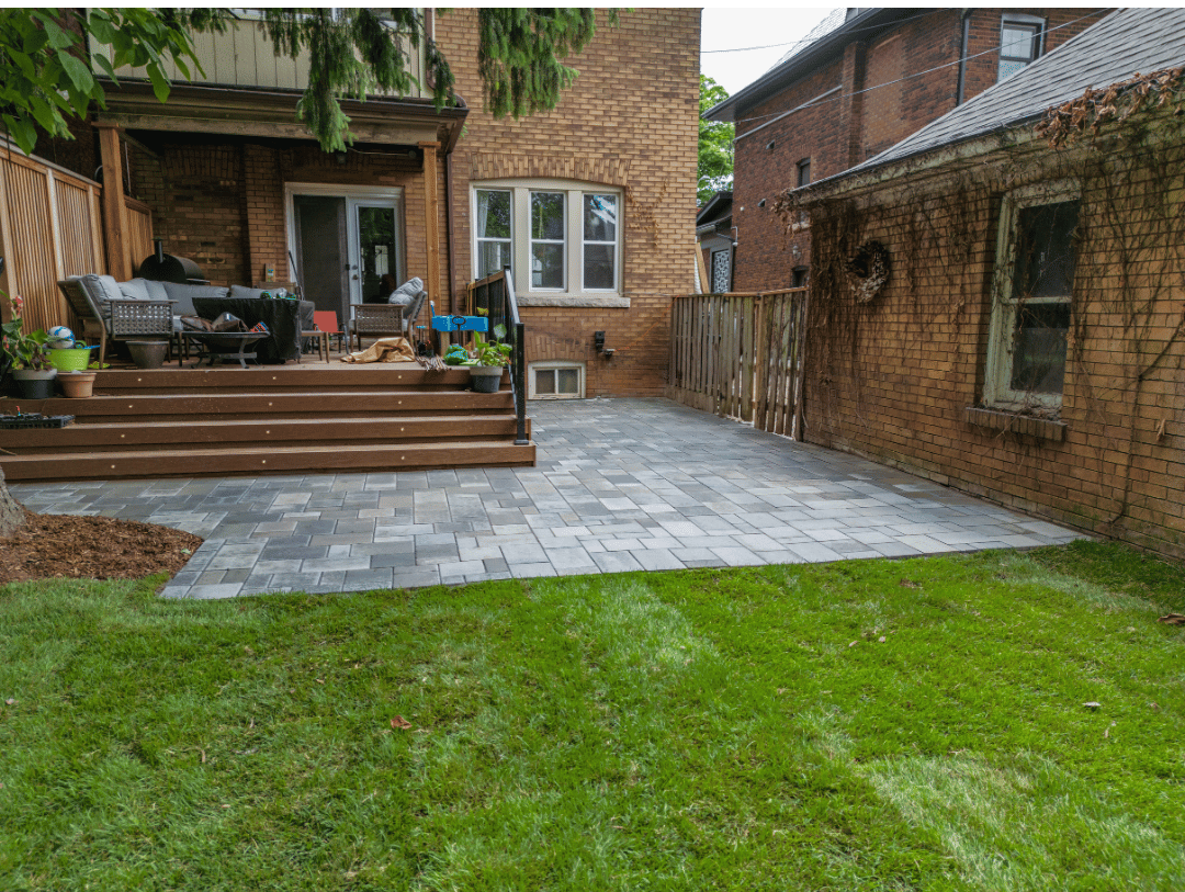 There is a patio in the backyard of a house.