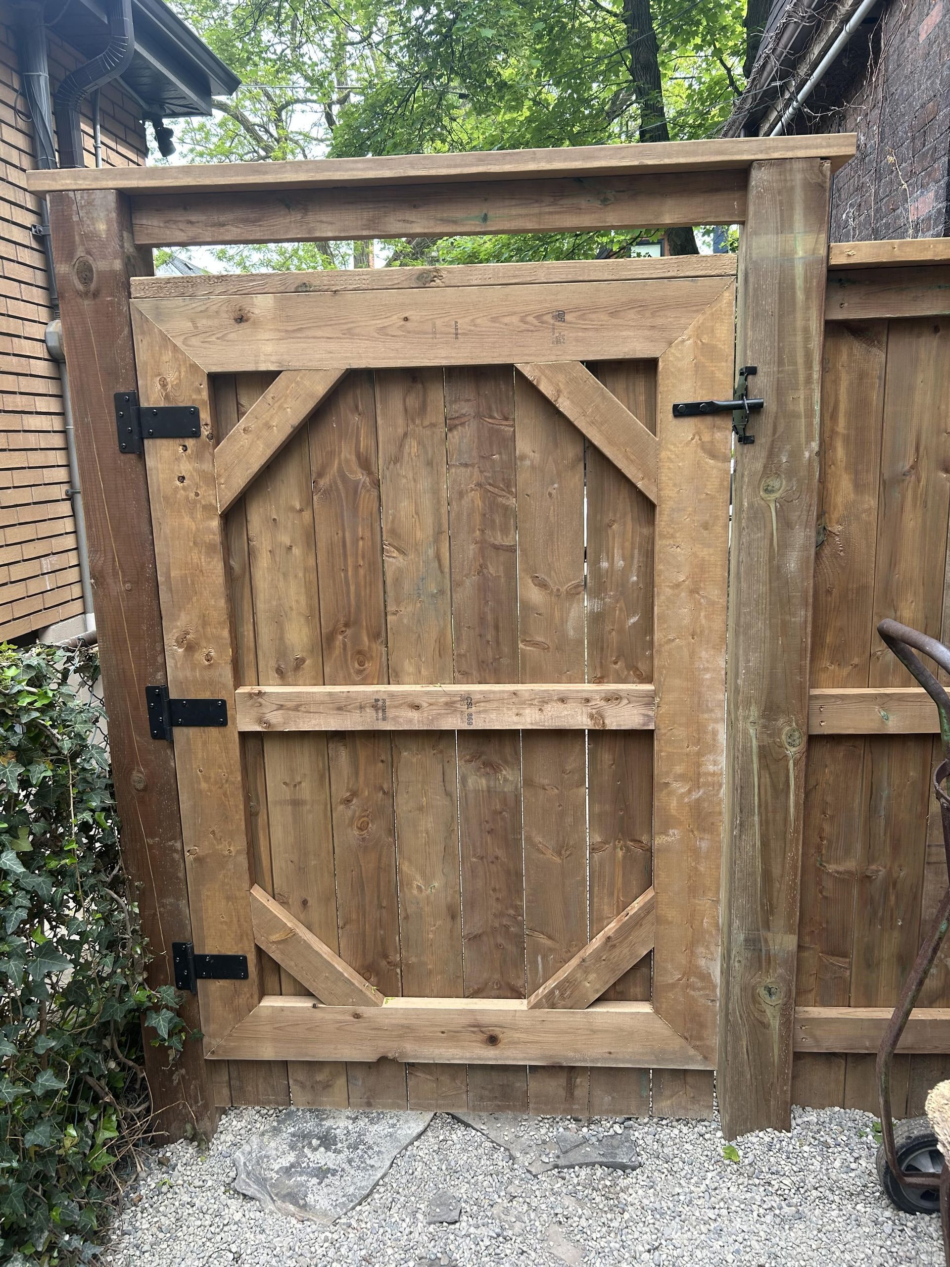 A wooden fence with a gate in the middle of it.