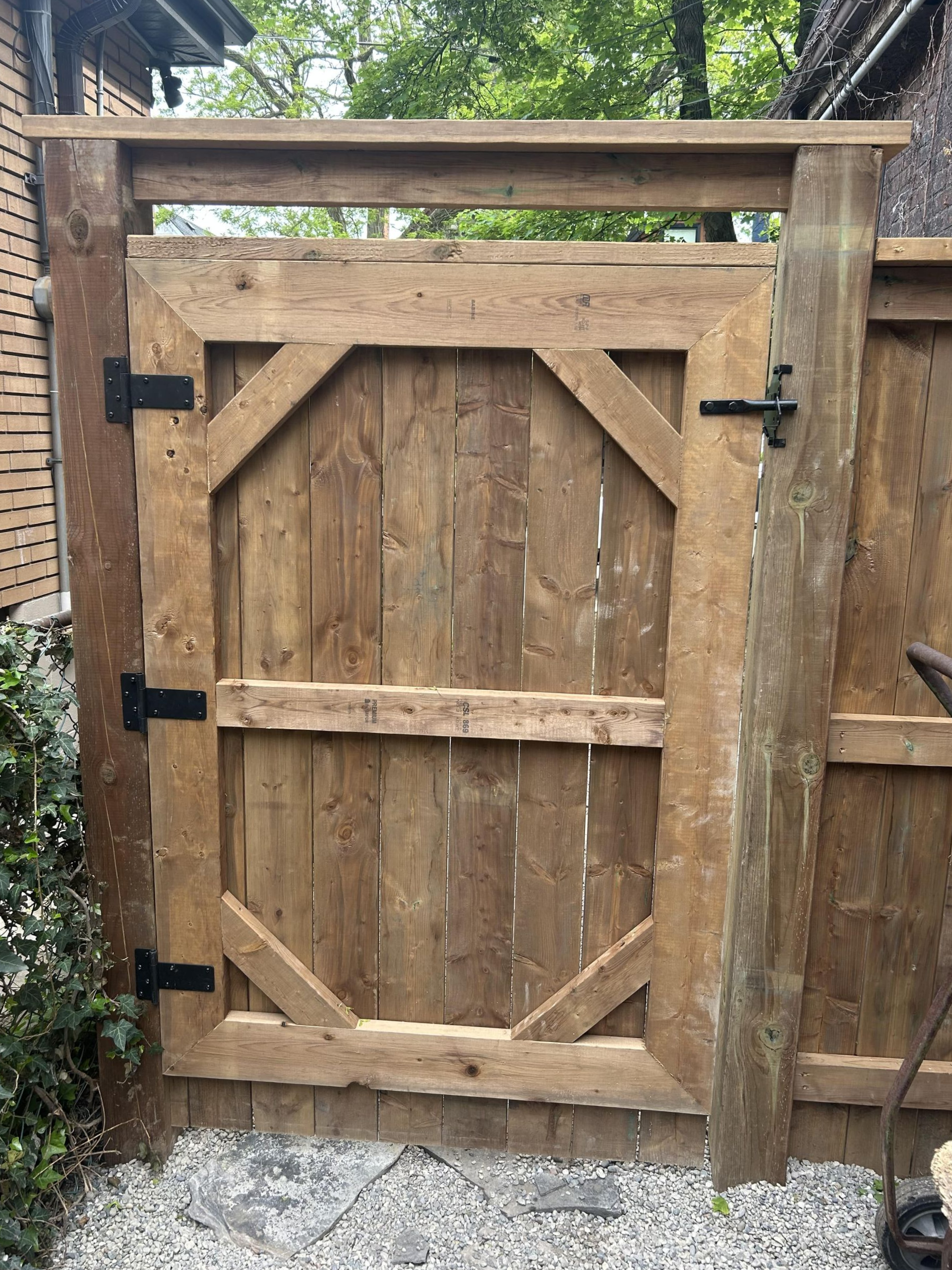 A wooden fence with a gate in the middle of it.