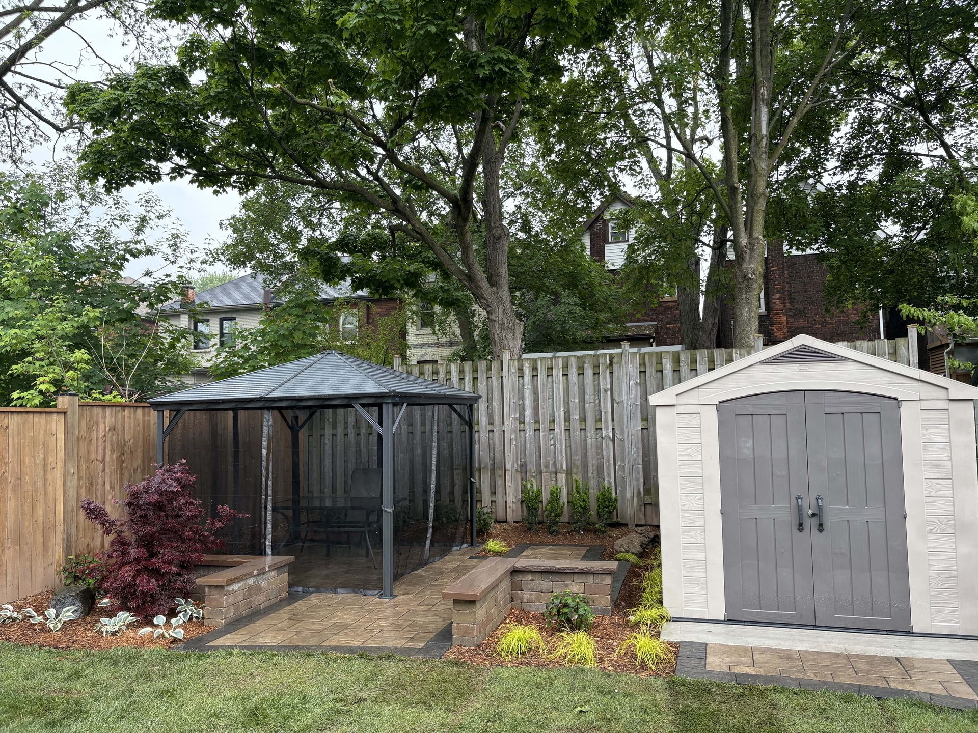 There is a gazebo and a shed in the backyard.
