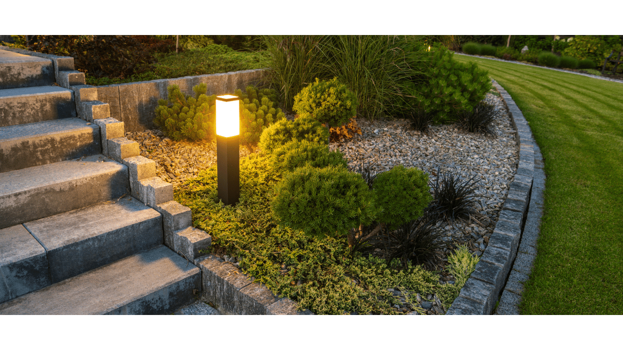 A garden with stairs and a lamp in the middle of it.