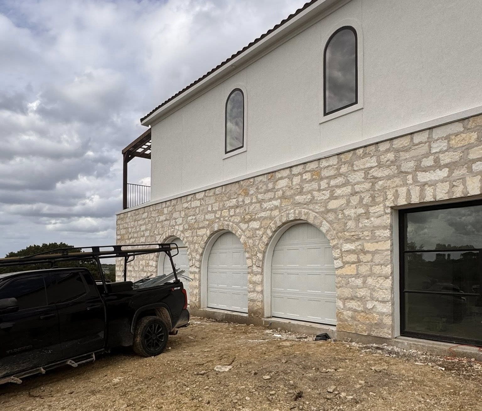 fancy Taylor TX home with triple arched garage door cutouts after a new garage door installation