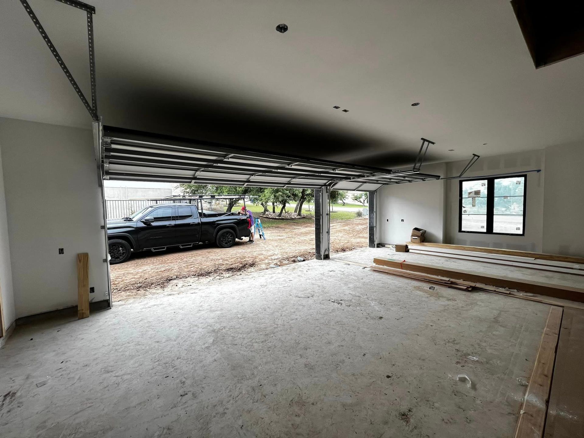 An empty garage with a truck parked in it.