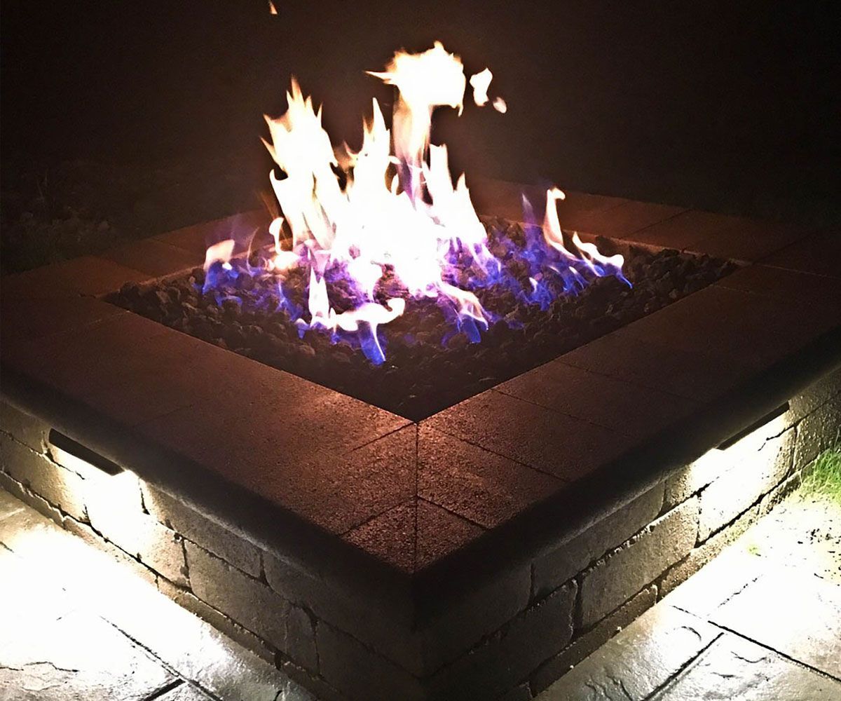 Rectangular gas fire pit on Bath paver patio designed and installed by Chidsey Landscape & Design