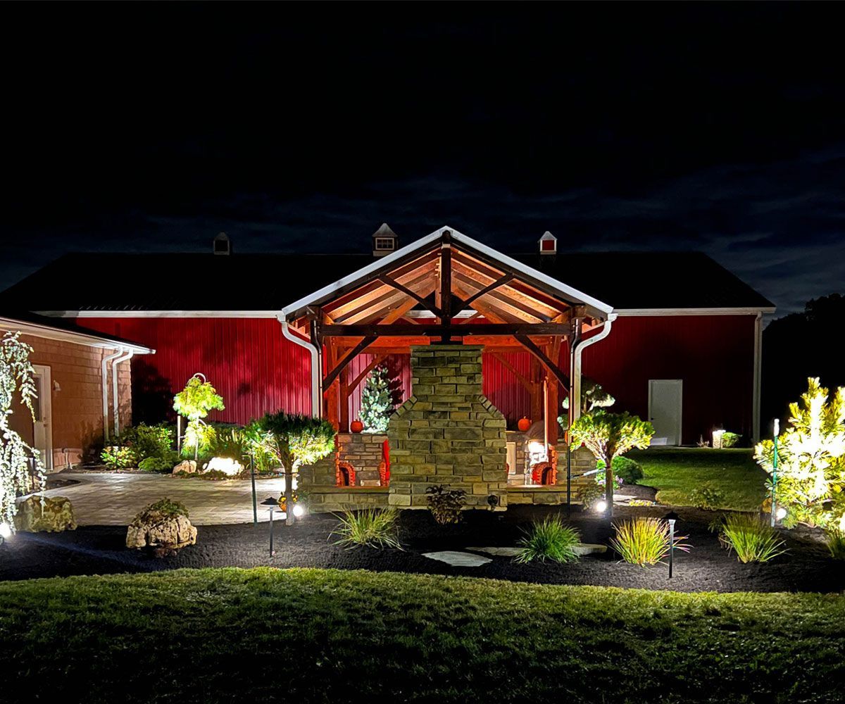Exterior landscape lighting of Medina home backyard patio by Northeast Ohio landscaper Chidsey Landscape and Design