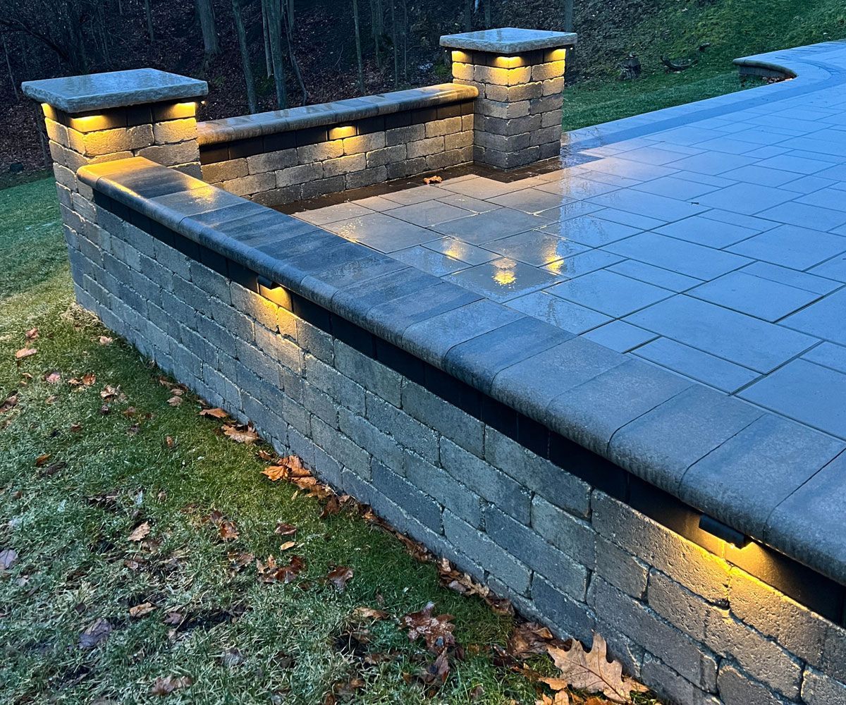 Retaining wall outdoor landscape lighting designed and installed by Chidsey Landscape & Design of Summit County Ohio home.