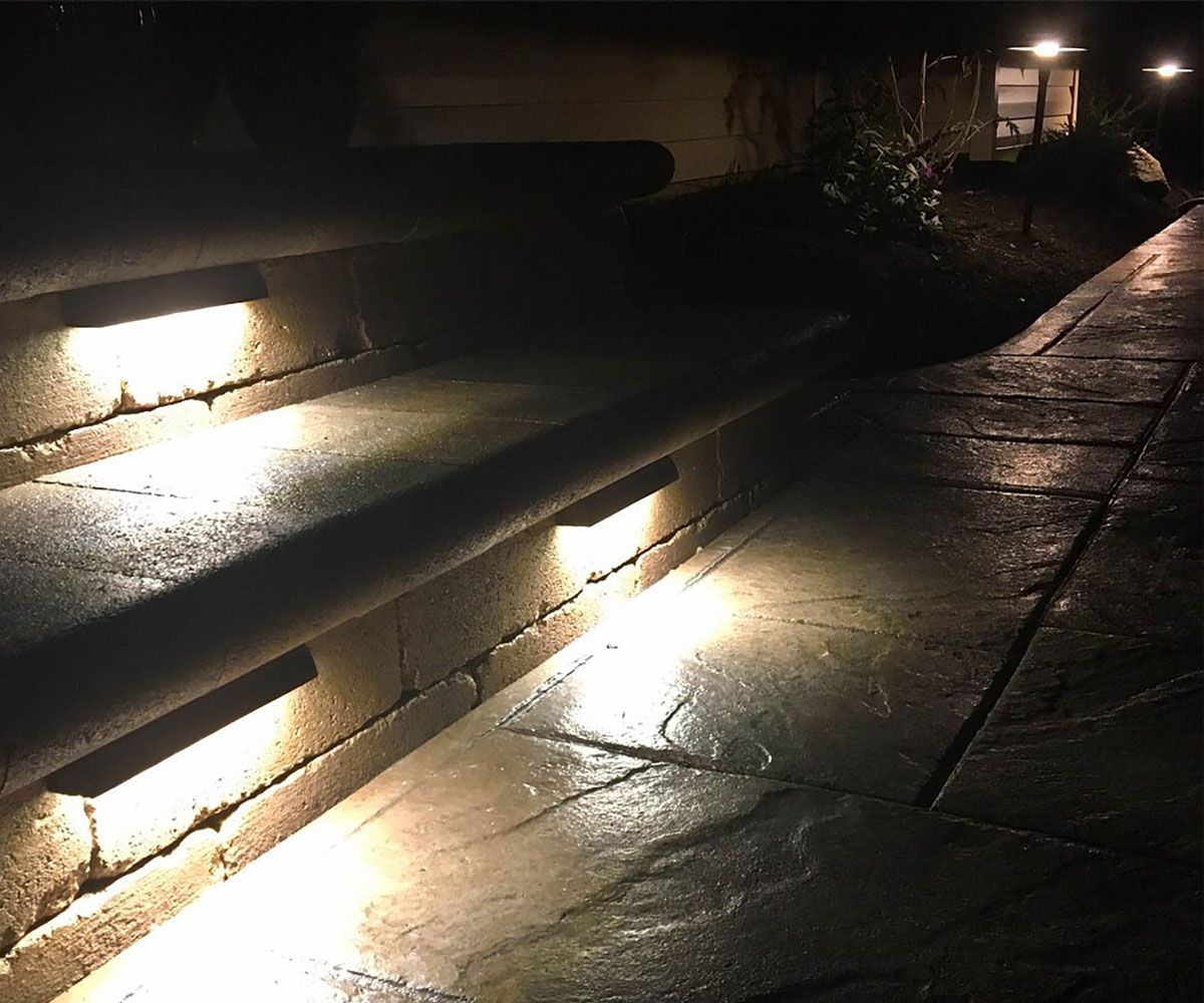Outdoor paver stone steps with step landscape lighting of Cuyahoga County, Ohio home backyard
