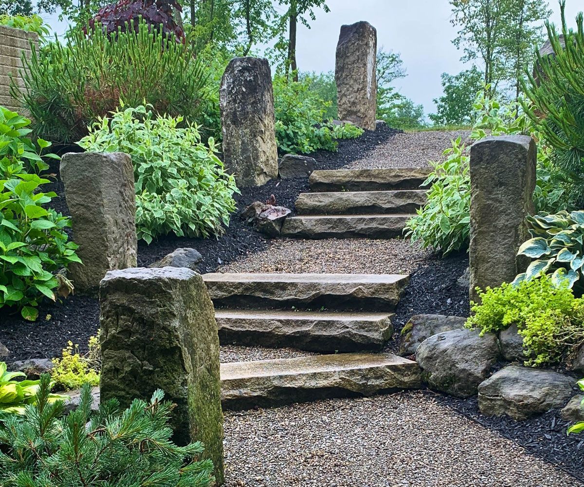 Natural landscape stone steps and barnstone columns at Medina home installed by Cleveland landscape contractor Chidsey Landscape