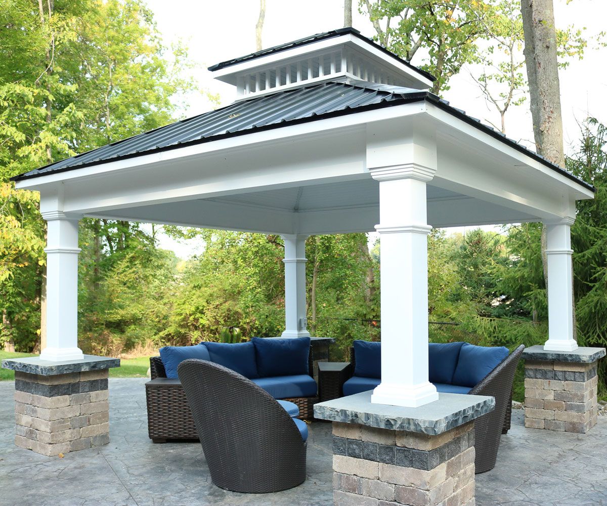Fade resistant vinyl outdoor pavilion with stone pillars covered outdoor furniture on Lorain County backyard patio.