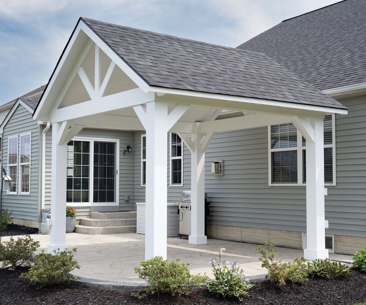 Patio sized high quality vinyl pavilion in Summit County backyard with gas grill and garden planting beds