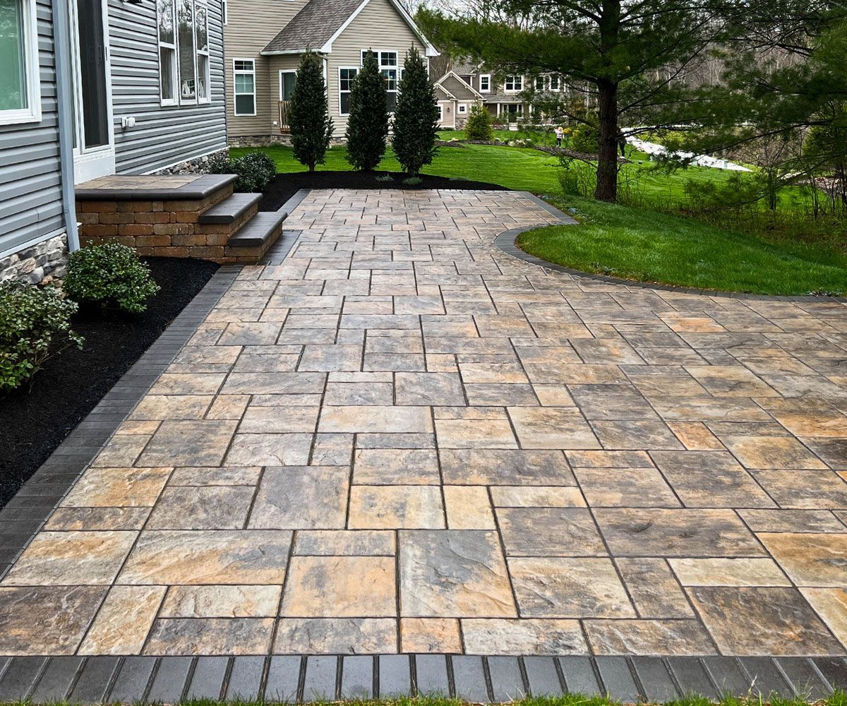 Backyard paver patio and paving stone block steps of Medina, OH home installed and designed by Northeast Ohio landscape contractor Chidsey Landscape and Design