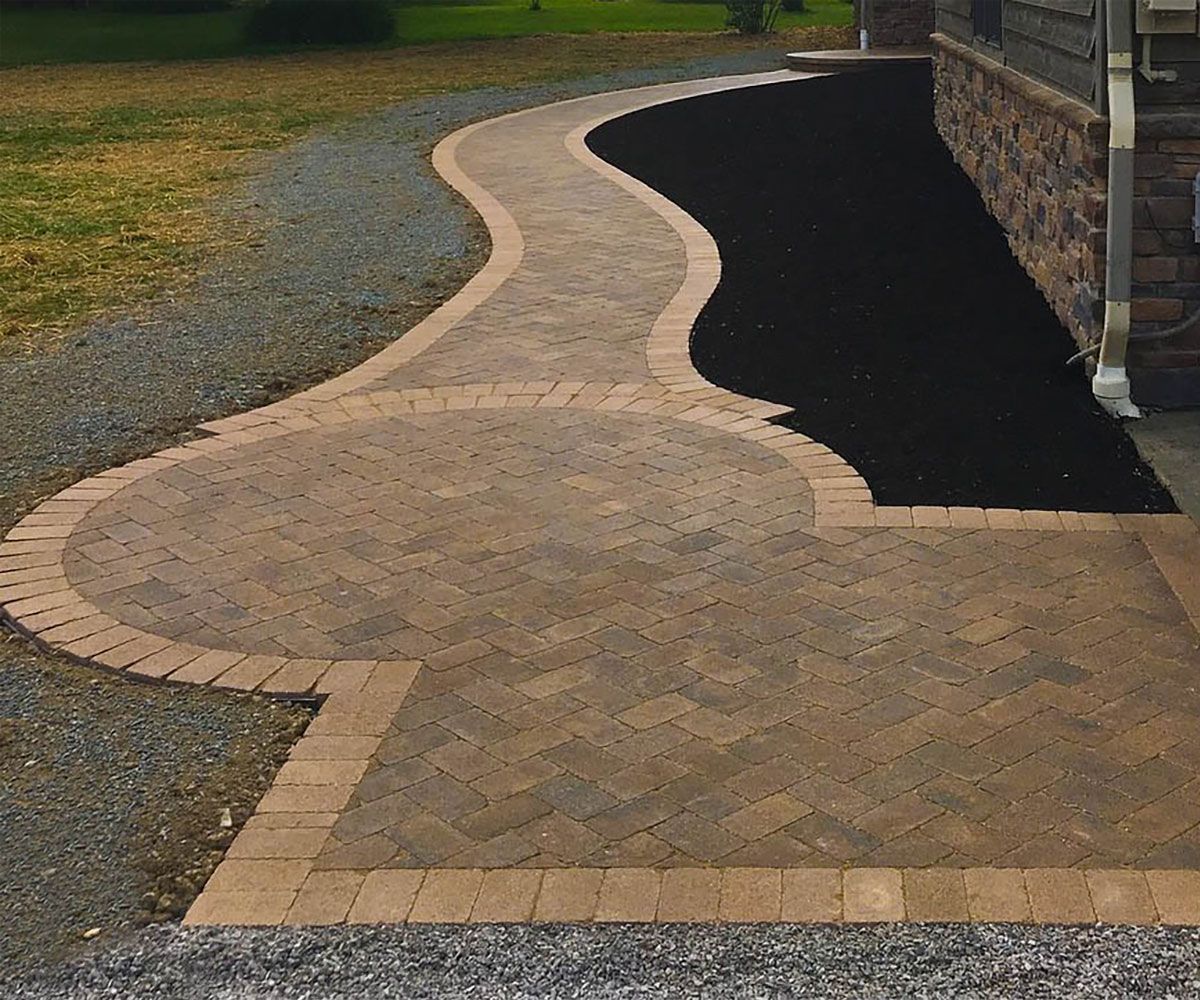 Custom circular paver front entrance of Bath, OH house with matching border