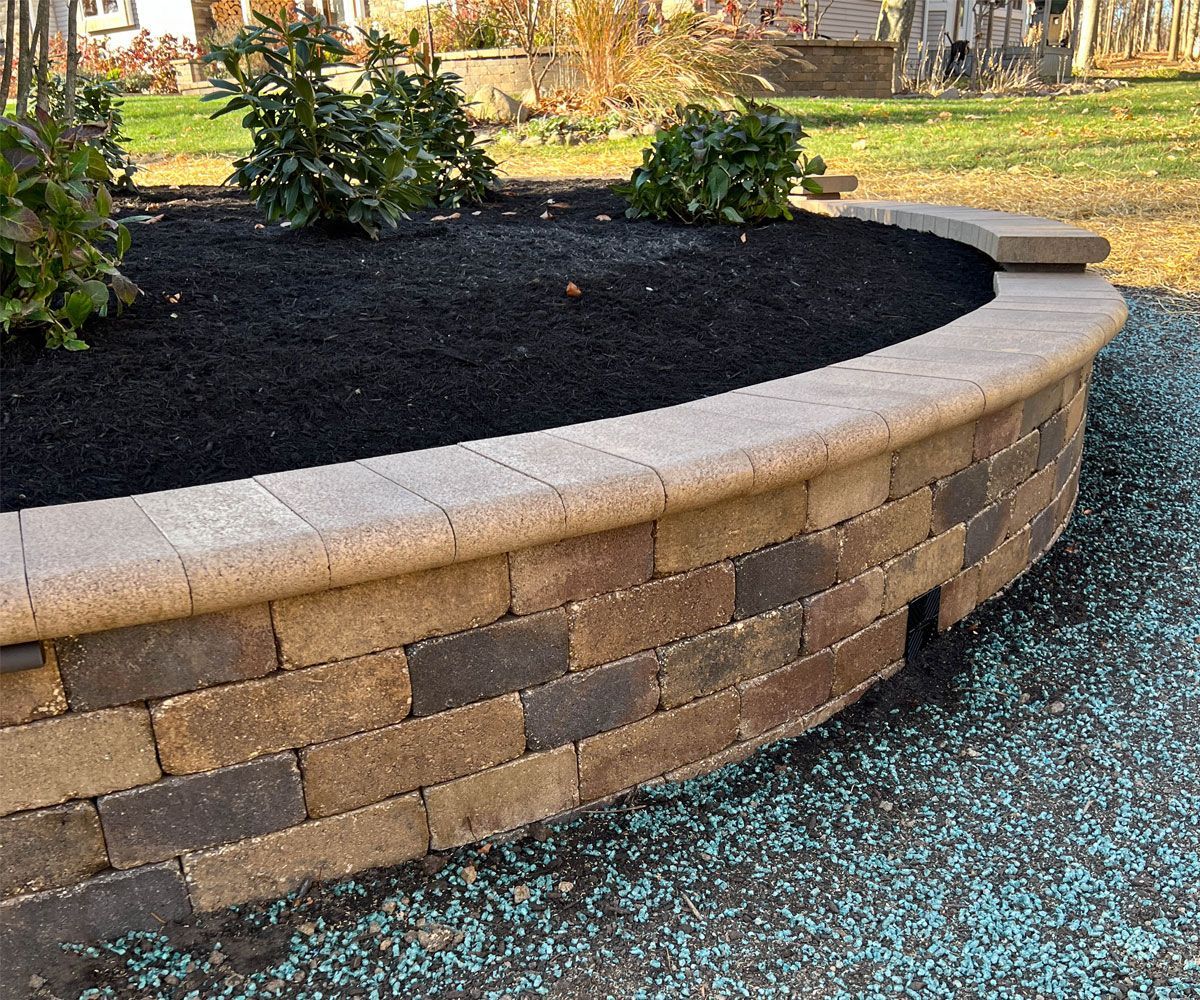 Medina, Oh raised garden bed enclosed with paver block retaining wall by Chidsey Landscape and Design