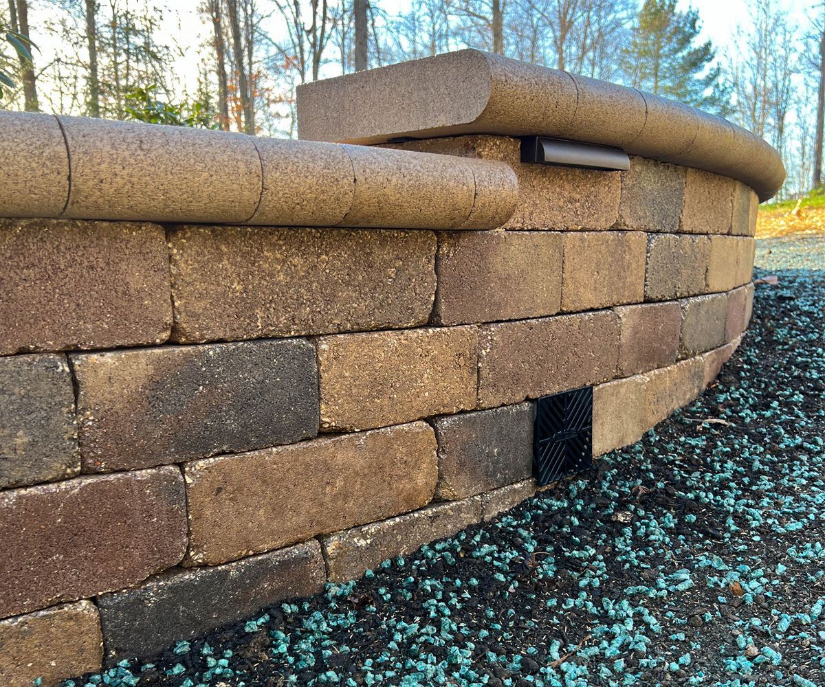 Hudson, OH backyard retaining wall design and installation for sloped hill and drainage solution