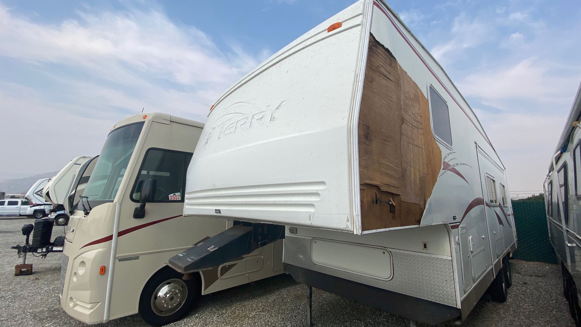 Mechanic works on a bus panel in a garage. Man uses a ruler and wears work overalls. Mechanic works on a bus panel in a garage. Man uses a ruler and wears work overalls.