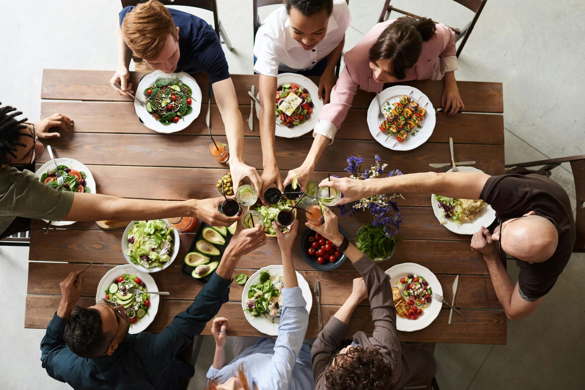 healthy mediterranean meal shared among a friendly group of people
