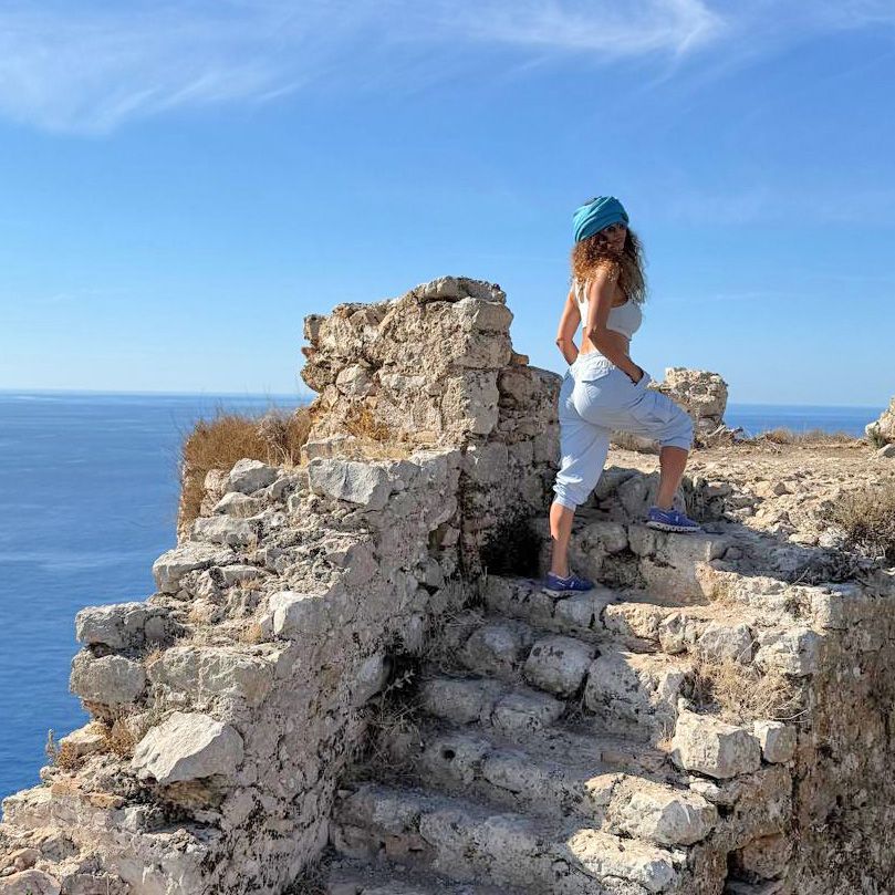 Tammy ascending a stone staircase on a seaside walk
