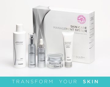 A set of skincare products in a box that says transform your skin