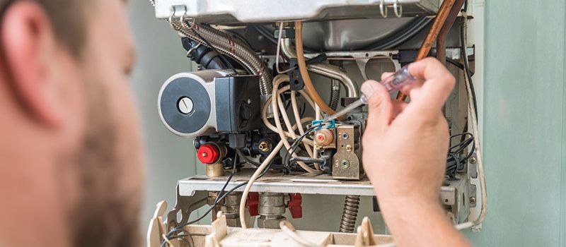 Heat Pump Repair — Man Fixing Heat Pump in Hickory, NC