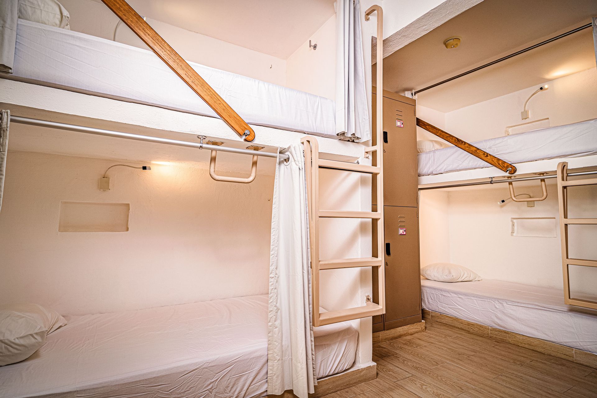 A room with bunk beds and a ladder in it in Nomads the best hostel in the zone