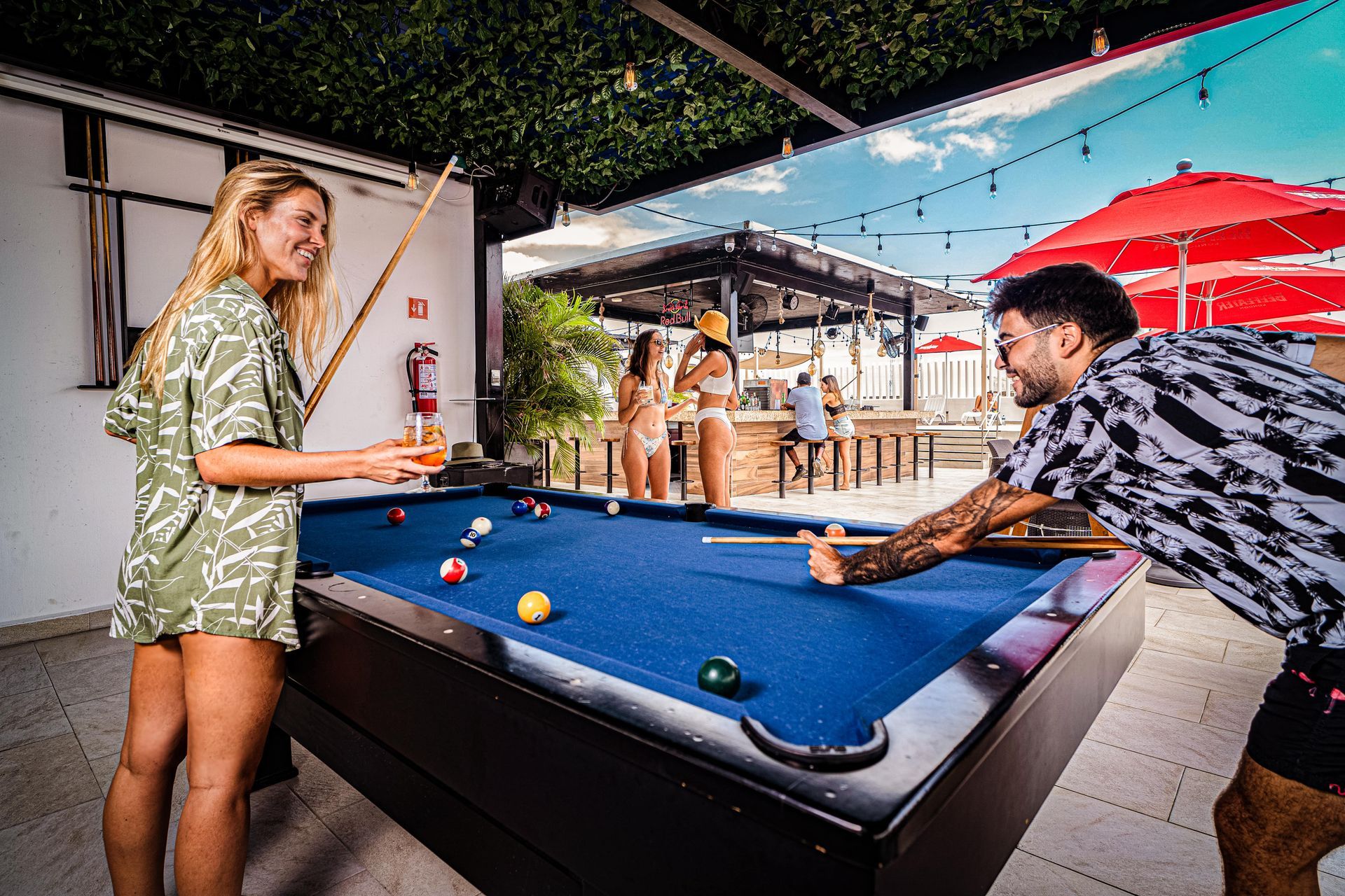 A man and a woman are playing pool on a pool table in nomads the best hotel in cancun downtown