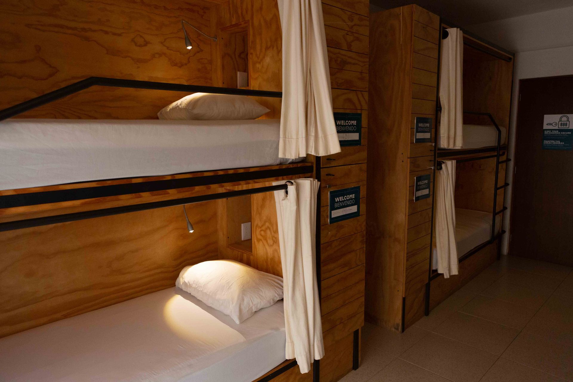 A row of bunk beds in a room with wooden walls.