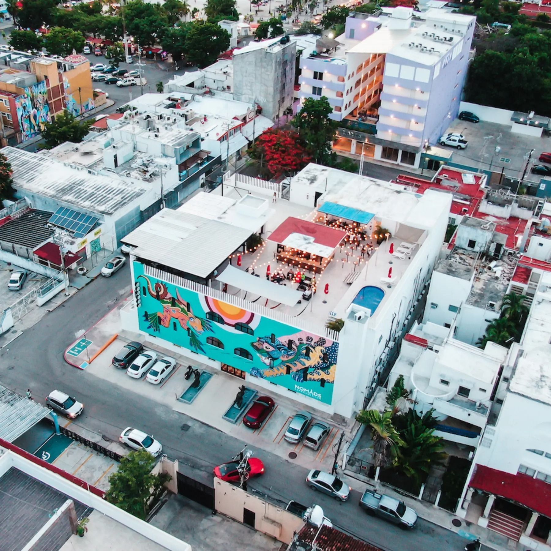 An aerial view of a city with a large mural on the side of a building