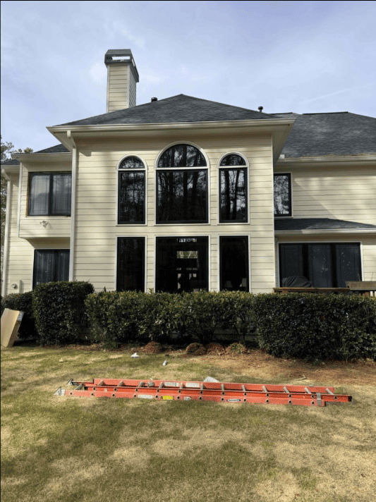 A large white house with arched windows and a black roof