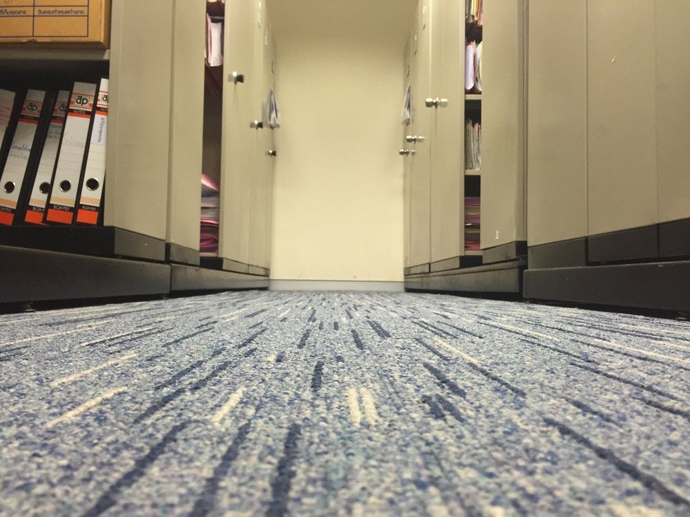 A Hallway With A Blue Carpet And A Row Of Filing Cabinets — Encore Carpet Professionals in Parkwood, QLD