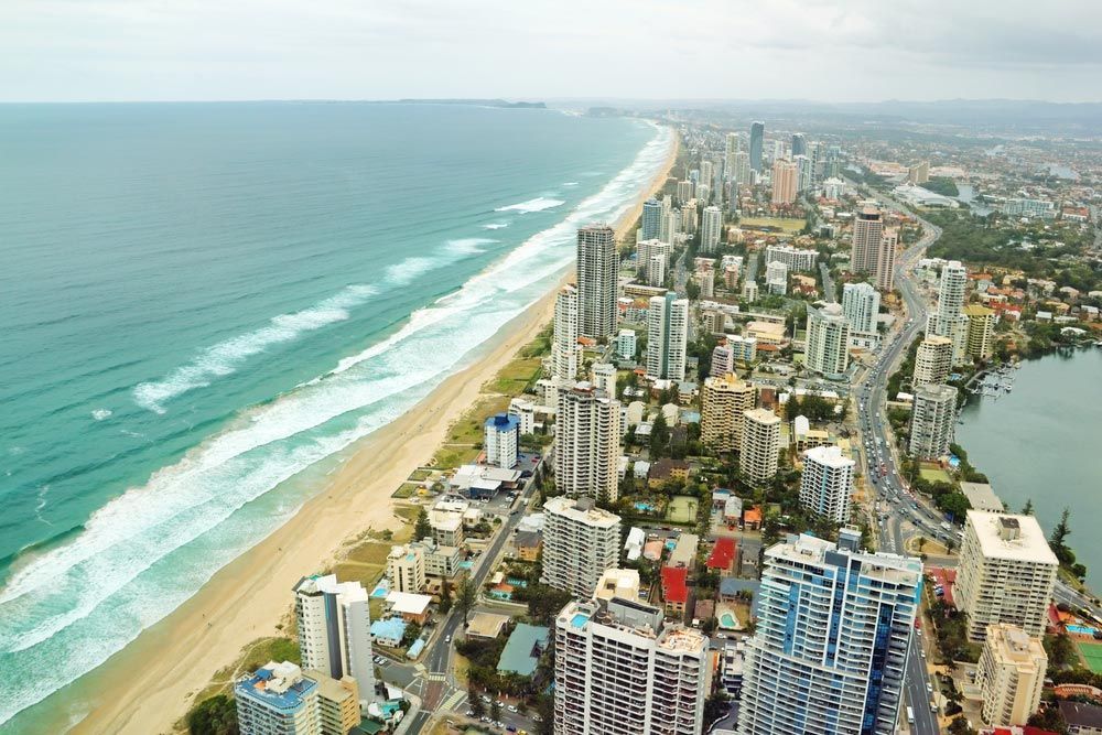 An Aerial View Of A City With A Beach And Ocean In The Background — Encore Carpet Professionals in Broadbeach, QLD