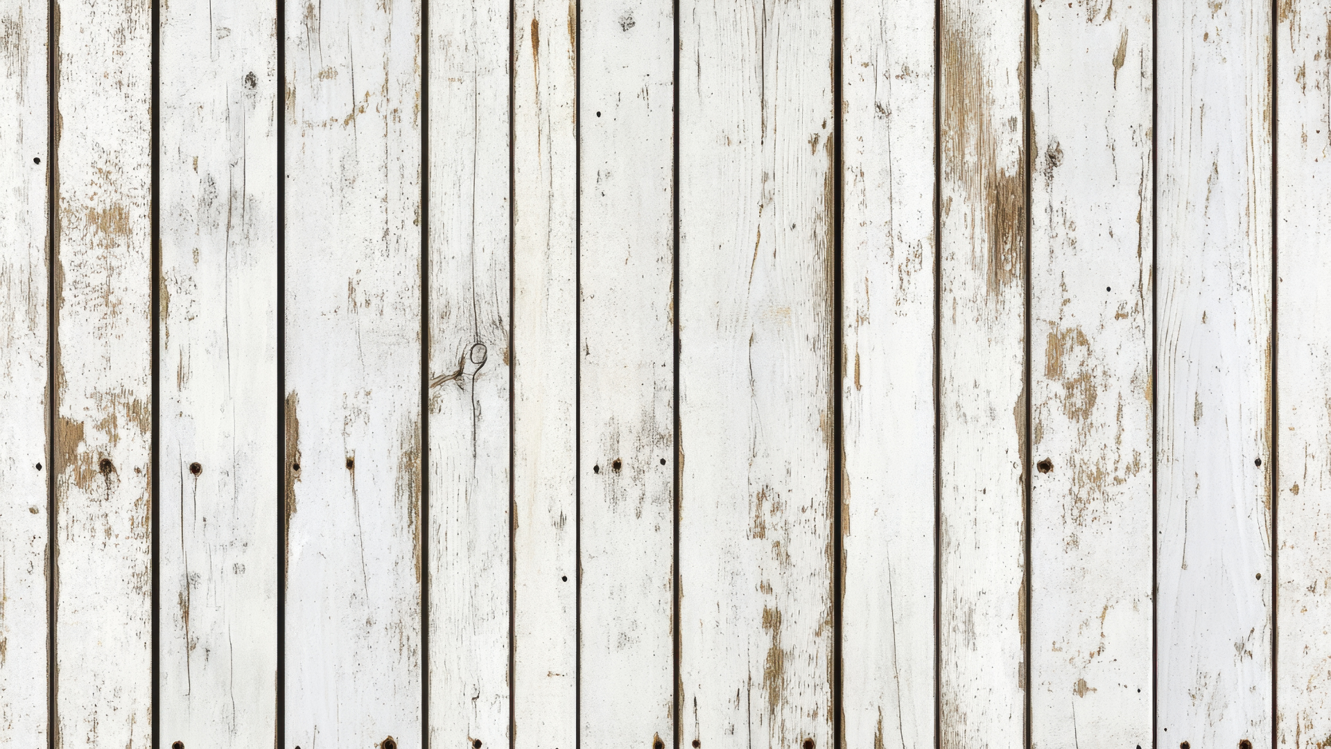 White, weathered wooden planks with vertical grain and some exposed wood, appearing old.