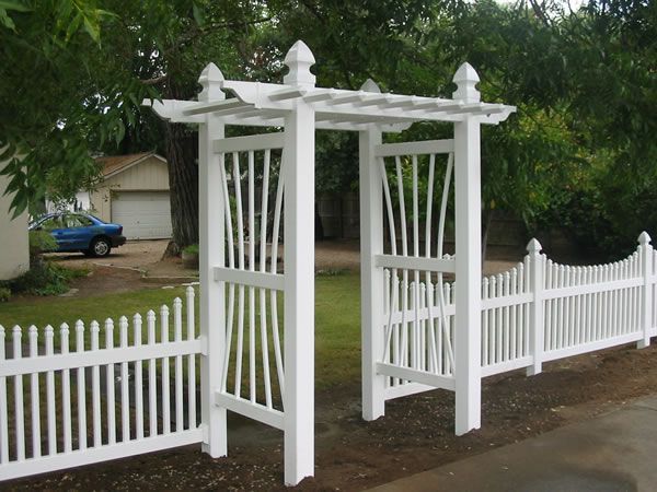 Wooden double gate with metal supports in a paved pathway.