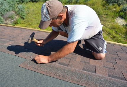 a roofer fixing a roof