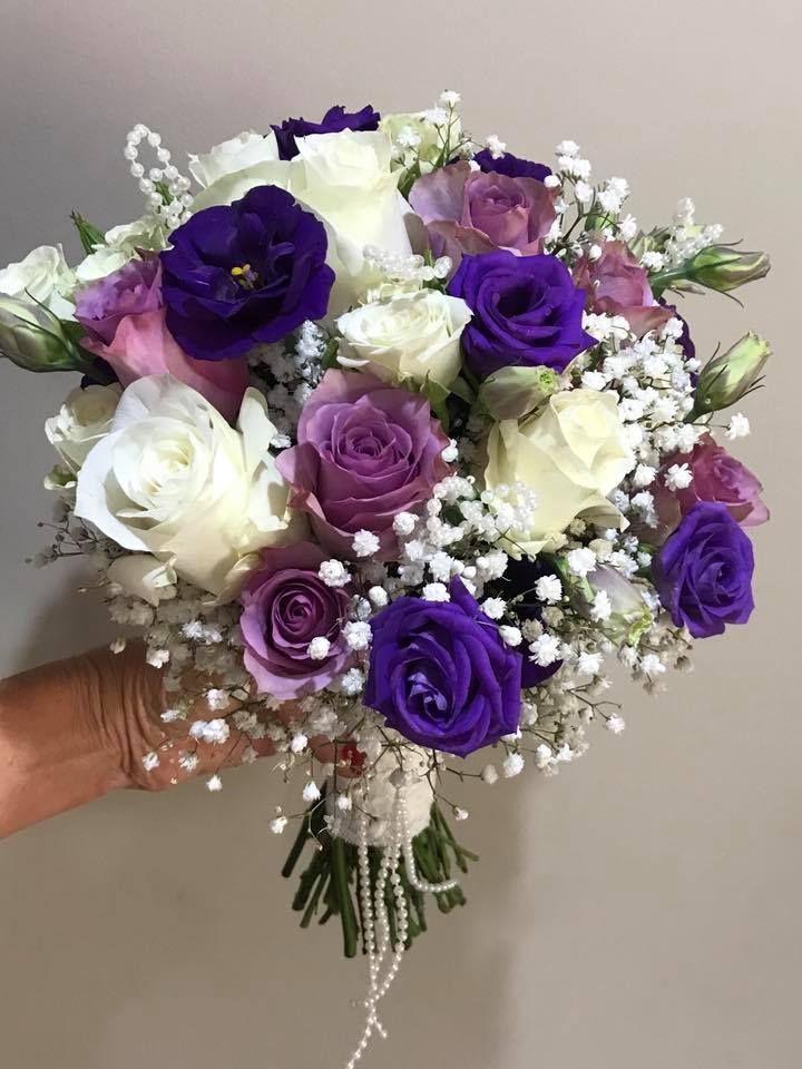 Hand Holding a Bouquet of White, Purple, and Pink Roses — Denise's Flower Studio In Dubbo, NSW