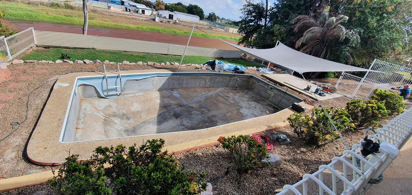 A Swimming Pool is Being Built in the Backyard of a House — NQ Tropical Pools & Renovations in Cranbrook, QLD