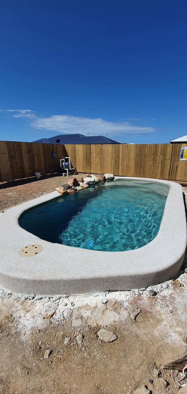 A Swimming Pool is Being Built in the Backyard of a House — NQ Tropical Pools & Renovations in Cranbrook, QLD
