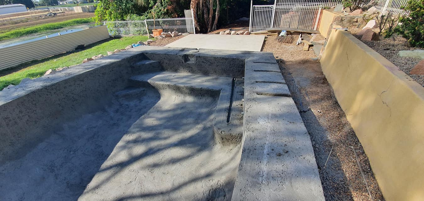 A Swimming Pool is Being Built in the Backyard of a House — NQ Tropical Pools & Renovations in Cranbrook, QLD