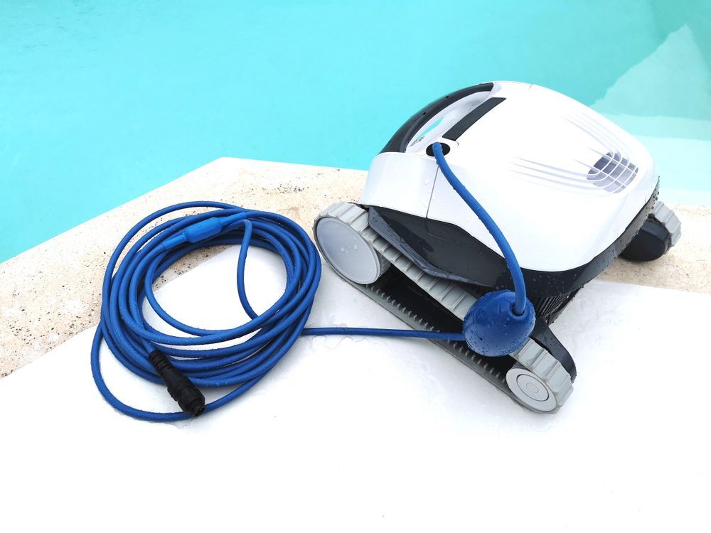A Robotic Pool Cleaner With a Blue Cord Attached to It — NQ Tropical Pools & Renovations in Cranbrook, QLD