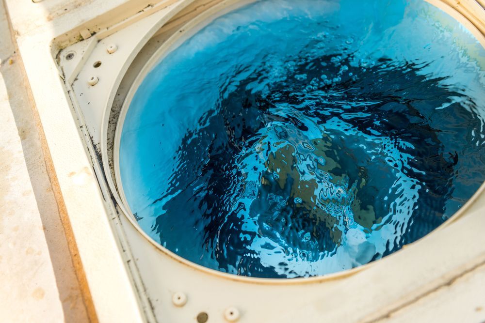 A Close Up of a Washing Machine With Blue Water in It — NQ Tropical Pools & Renovations in Cranbrook, QLD