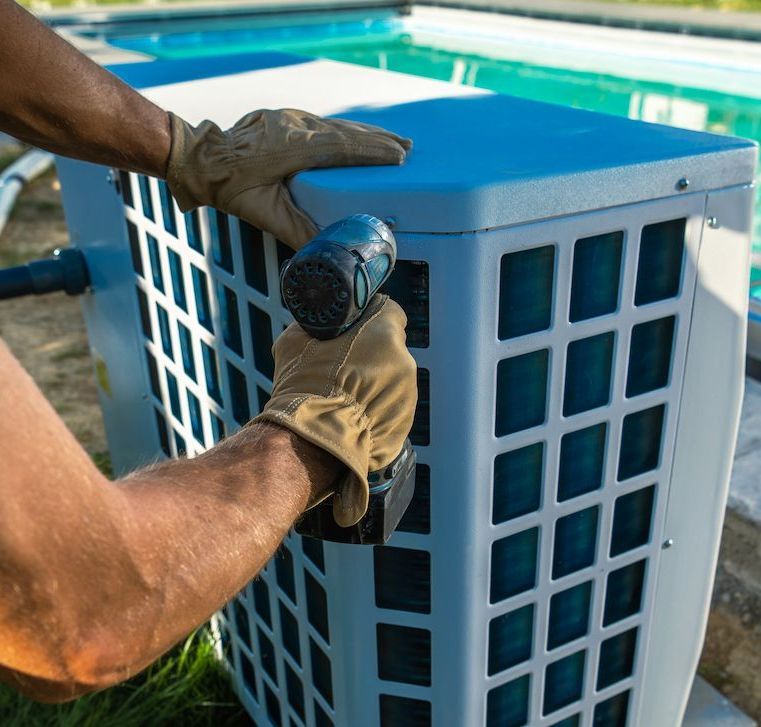 A Man is Working on an Air Conditioner Next to a Swimming Pool — NQ Tropical Pools & Renovations in Cranbrook, QLD