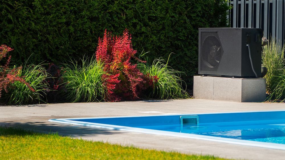 A Swimming Pool With a Heater on the Side of It — NQ Tropical Pools & Renovations in Cranbrook, QLD