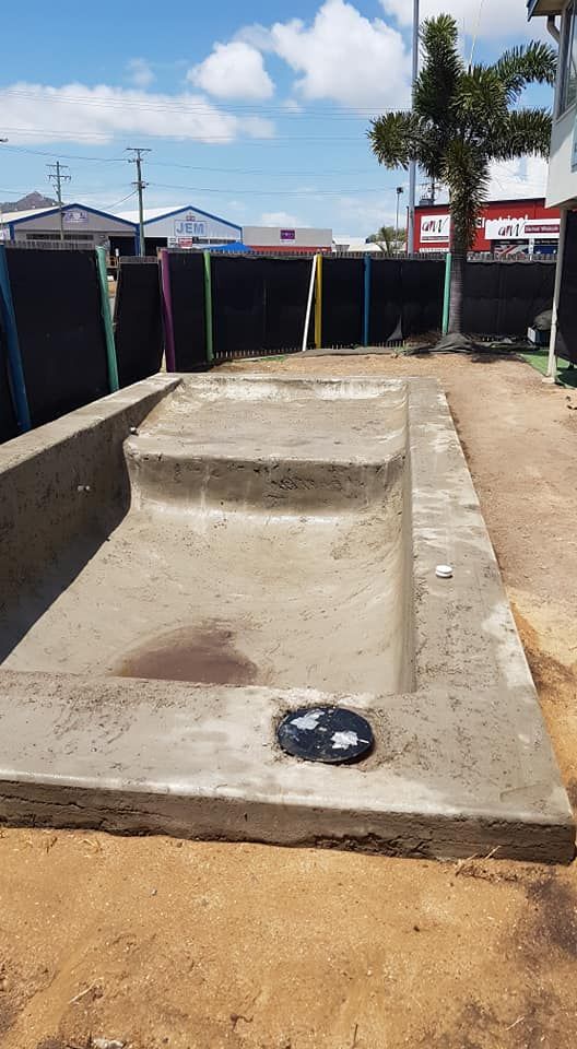 A Concrete Staircase is Sitting on Top of a Dirt Field — NQ Tropical Pools & Renovations in Ingham, QLD