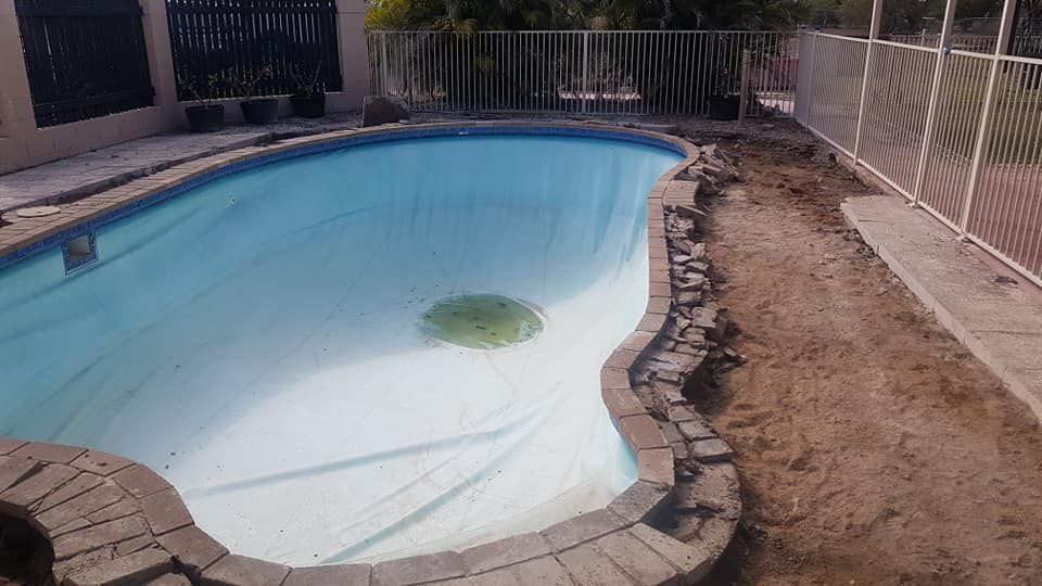 A Large Swimming Pool is Being Remodeled in a Backyard — NQ Tropical Pools & Renovations in Ingham, QLD